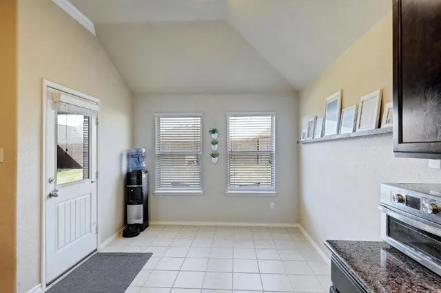 a kitchen with stainless steel appliances granite countertop a refrigerator and a stove top oven
