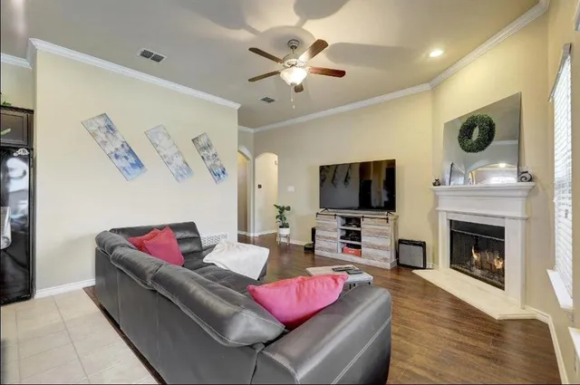 a living room with furniture kitchen view and a fireplace