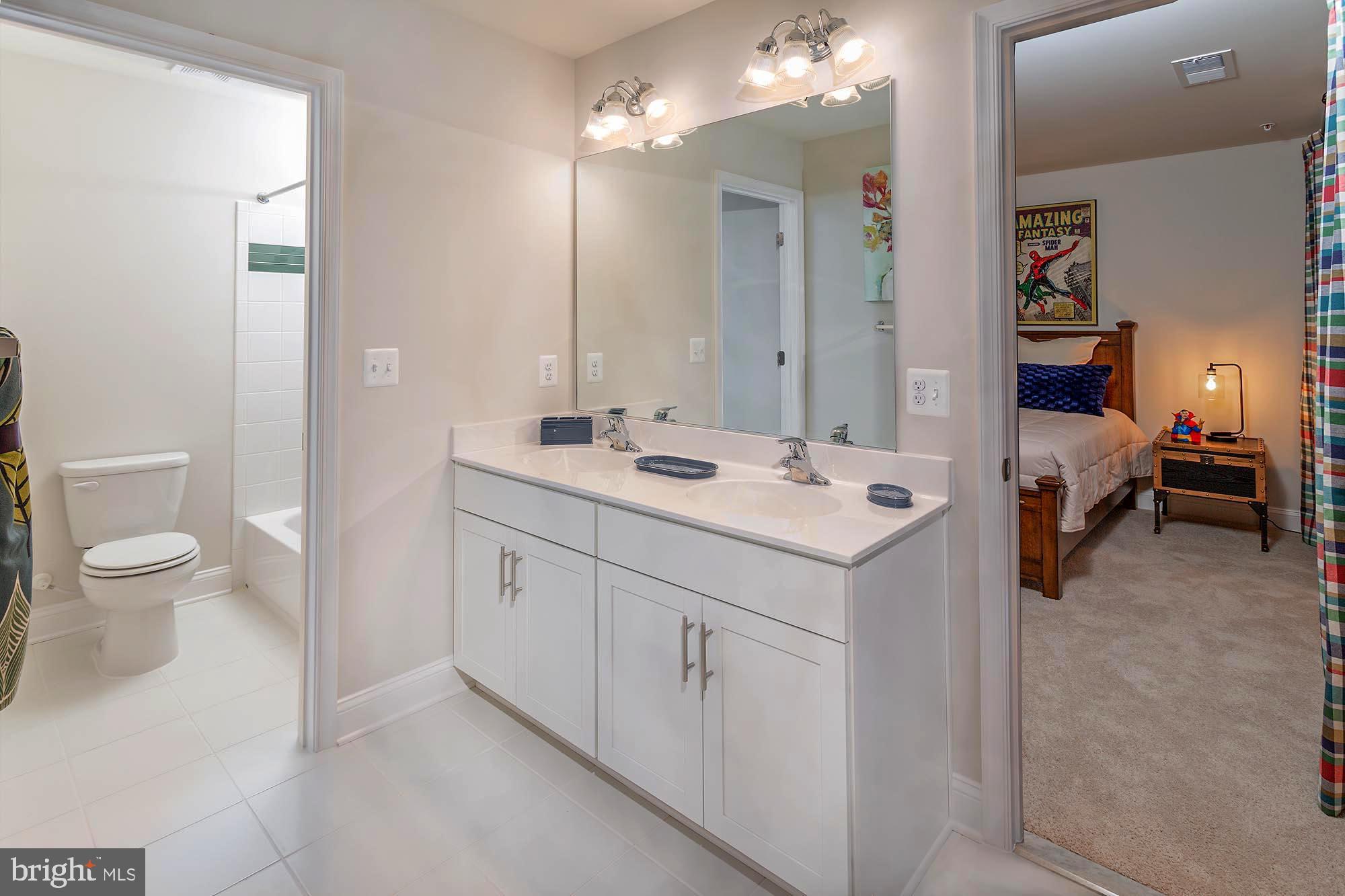 14617 Good Hope Road Silver Spring, MD 20905 - Photo 15 of 29 a spacious bathroom with a double vanity sink toilet and a mirror