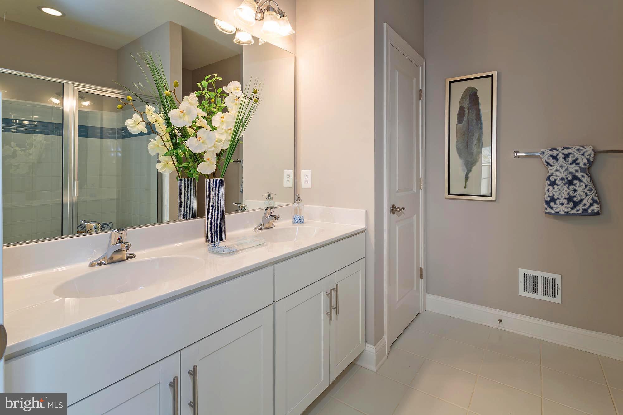 14617 Good Hope Road Silver Spring, MD 20905 - Photo 16 of 29 a bathroom with a double vanity sink and a mirror