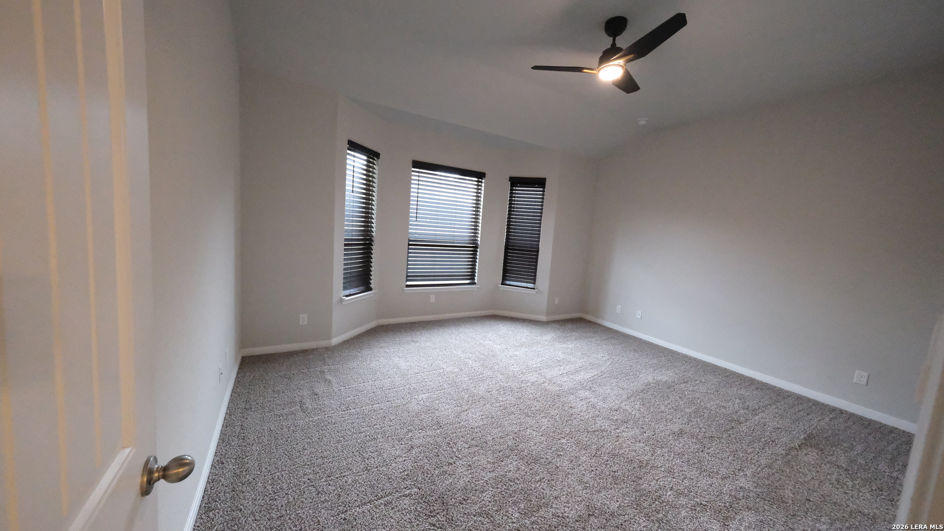 10335 Midsummer Converse, TX 78109 - Photo 19 of 24 an empty room with windows and fan