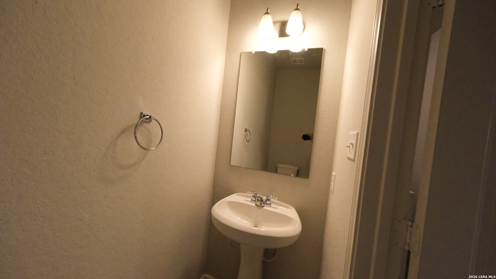 10335 Midsummer Converse, TX 78109 - Photo 20 of 24 a bathroom with a sink and a mirror