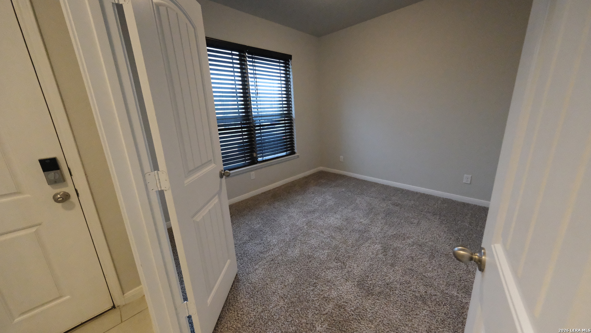 10335 Midsummer Converse, TX 78109 - Photo 21 of 24 a view of an empty room with a window