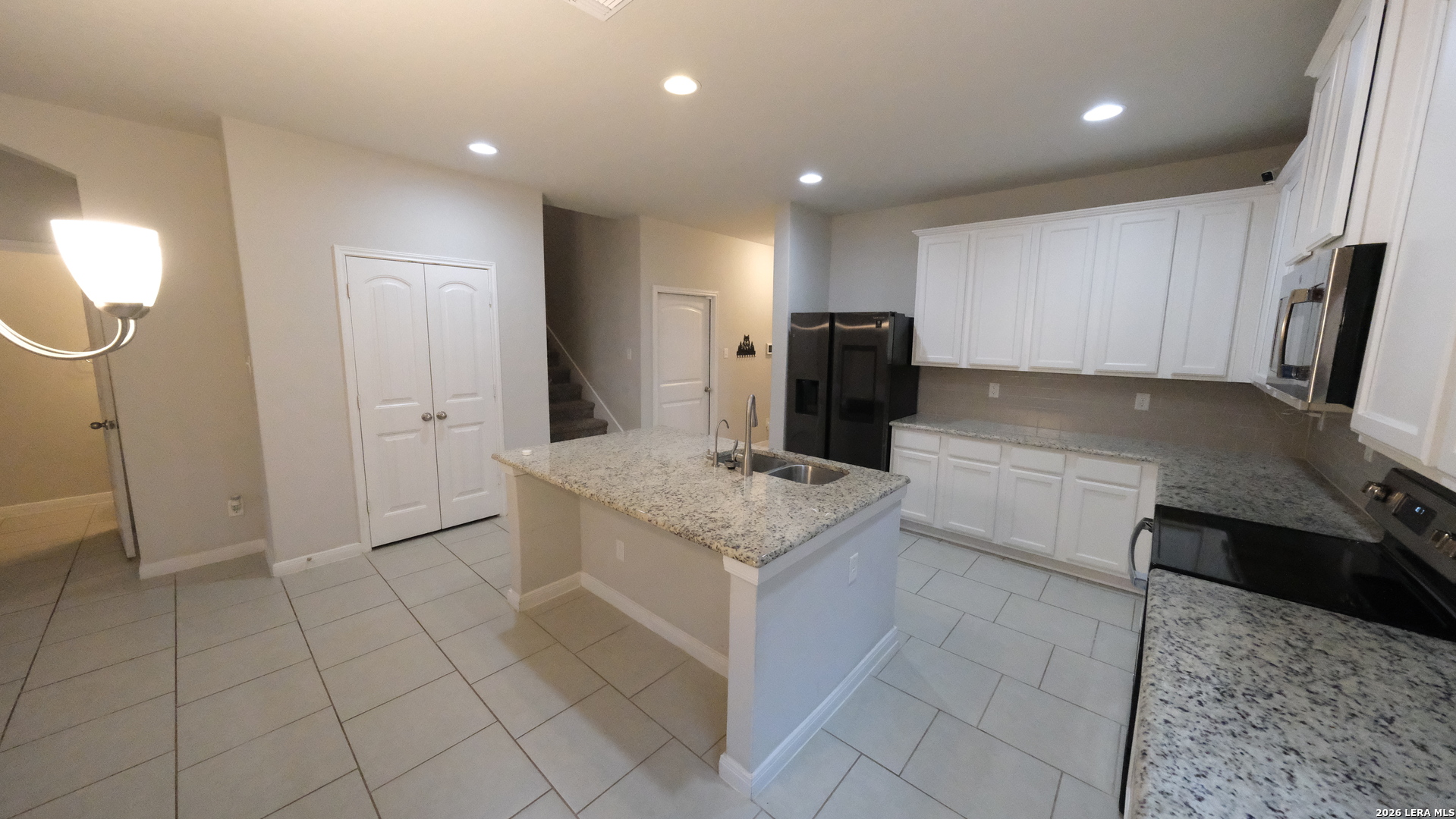 10335 Midsummer Converse, TX 78109 - Photo 23 of 24 a kitchen with stainless steel appliances a stove a sink and a refrigerator