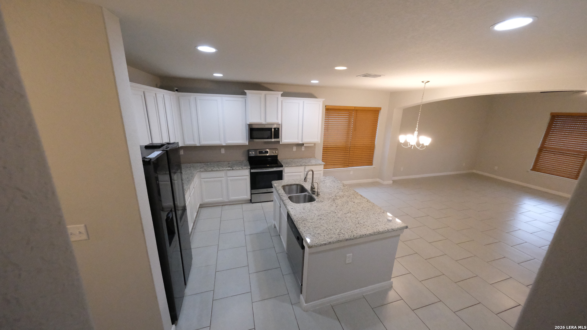 10335 Midsummer Converse, TX 78109 - Photo 5 of 24 a kitchen with stainless steel appliances a refrigerator and a sink