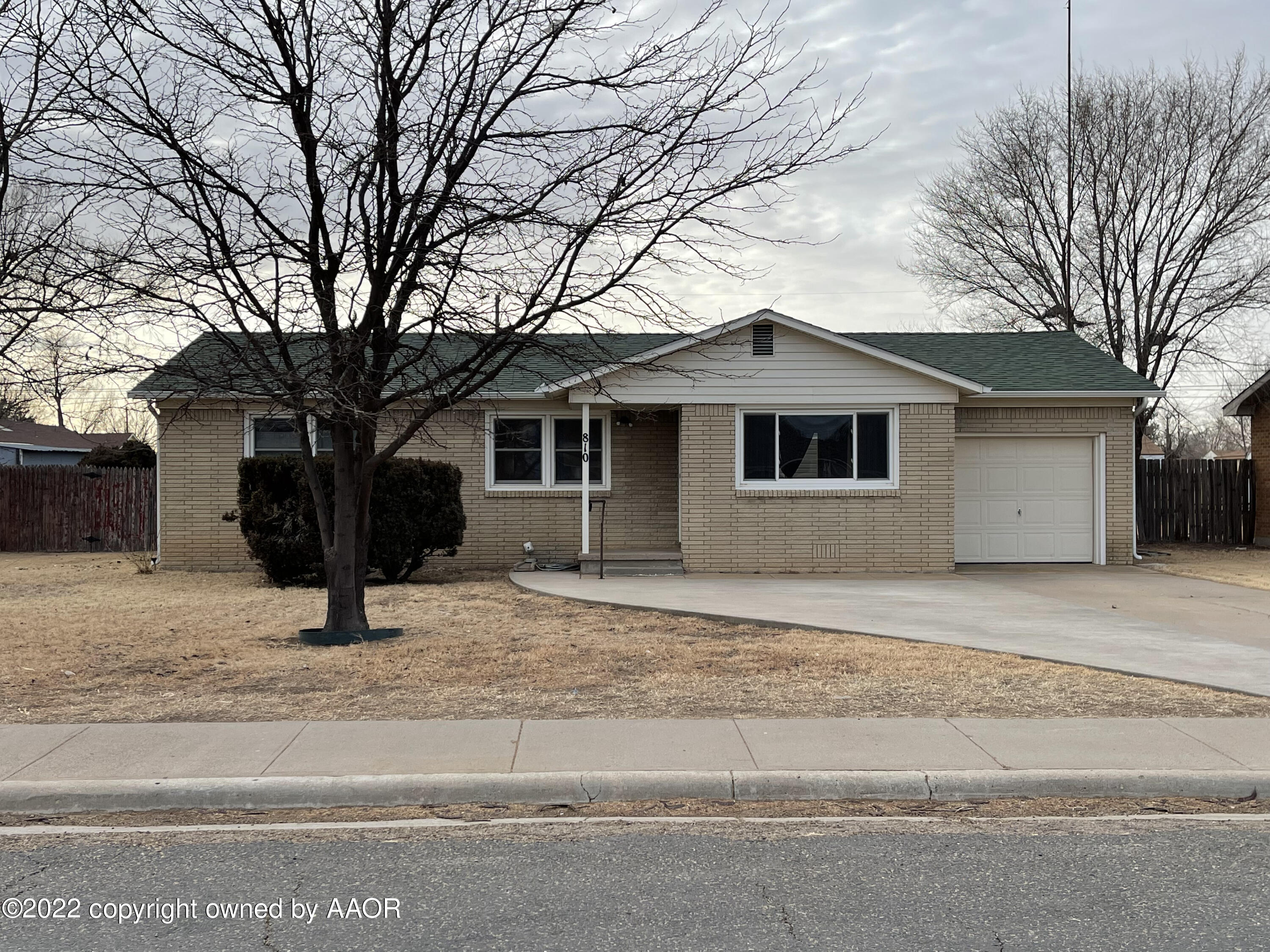810 Ave Q Sunray, TX 79086 - Photo 1 of 29 a house with trees in the background