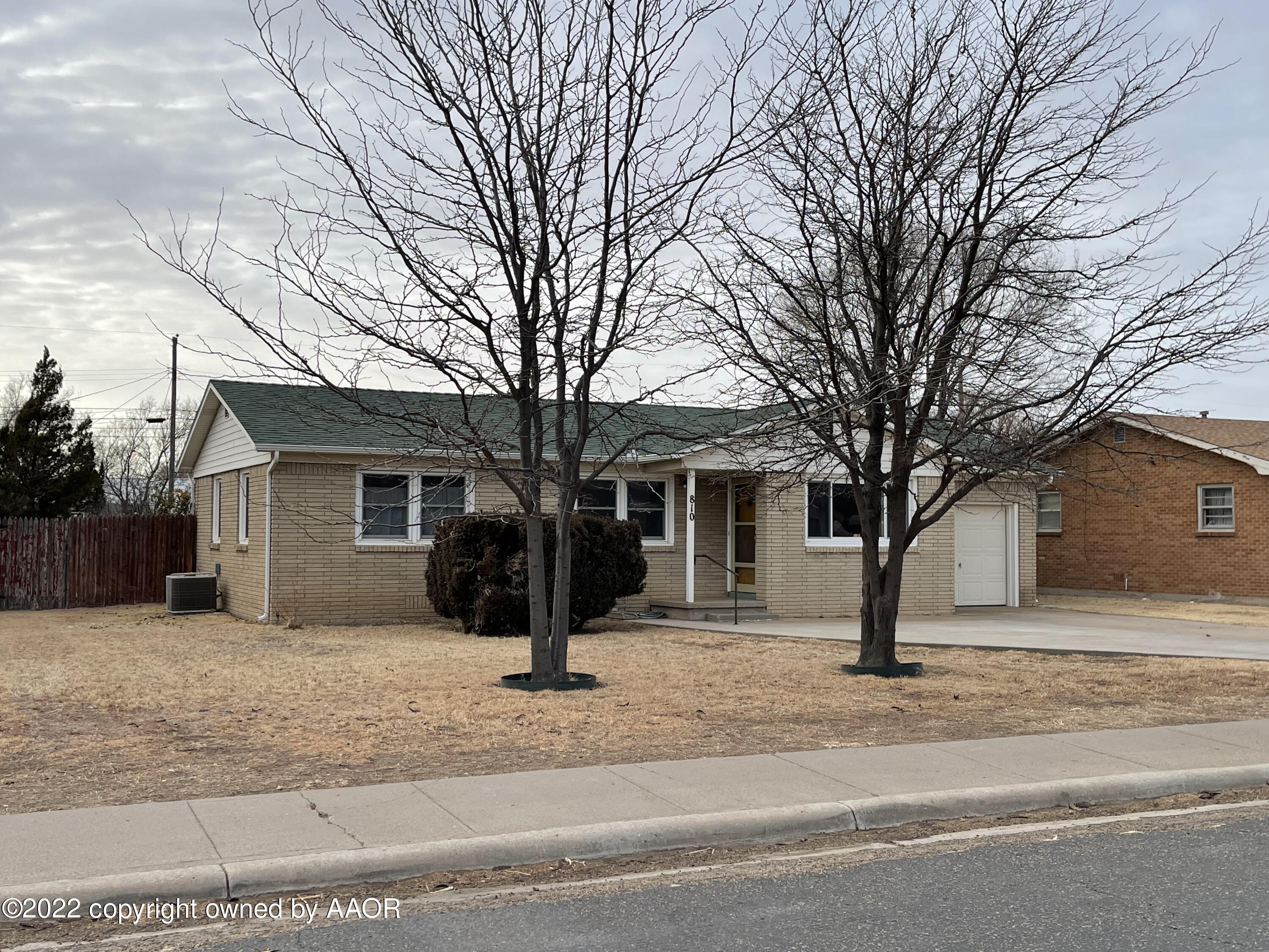 810 Ave Q Sunray, TX 79086 - Photo 2 of 29 a view of a house with a yard covered in snow