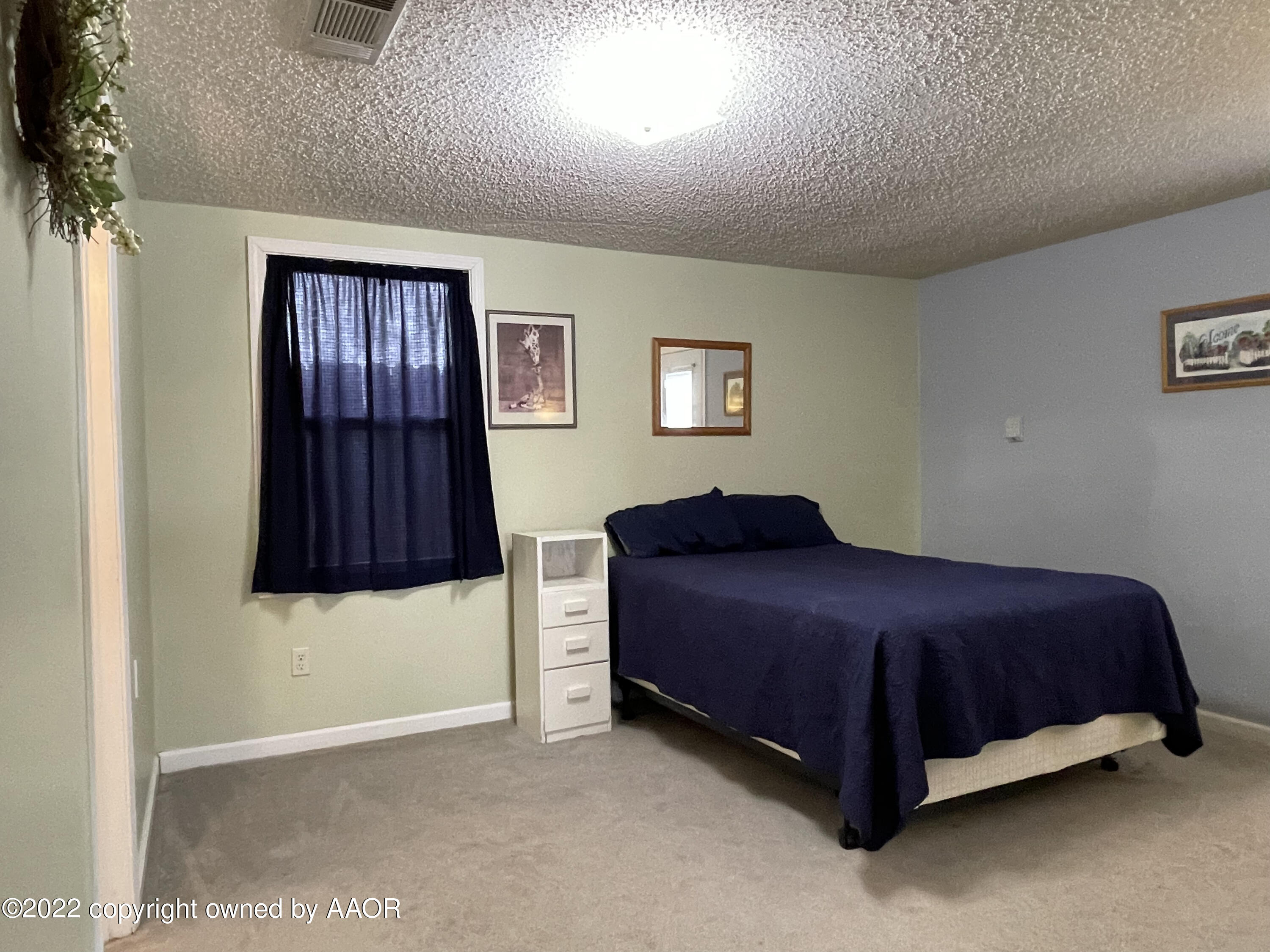 810 Ave Q Sunray, TX 79086 - Photo 19 of 29 a bedroom with a bed and a cabinets