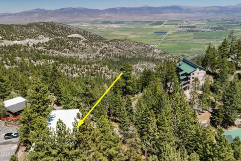 a view of a house with a mountain and mountains in the background