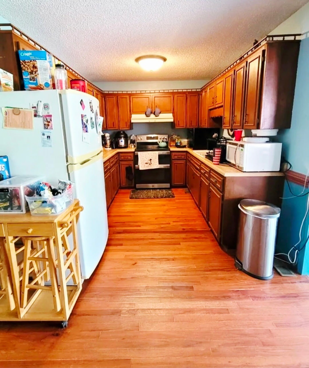 1360 Camden Bay Road Camden, TN 38320 - Photo 12 of 43 a large kitchen with stainless steel appliances wooden floors and wooden cabinets