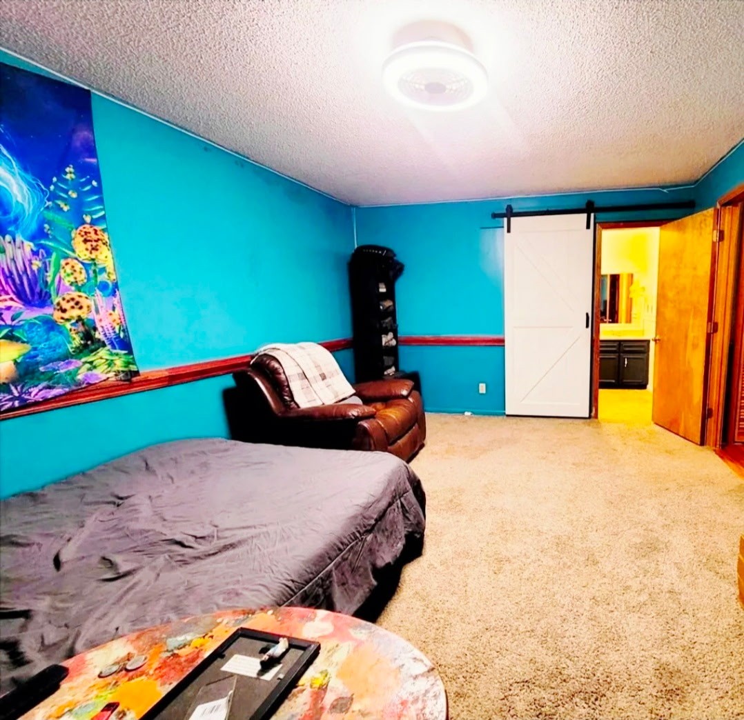 1360 Camden Bay Road Camden, TN 38320 - Photo 19 of 43 a bedroom with a bed and a painting on the wall
