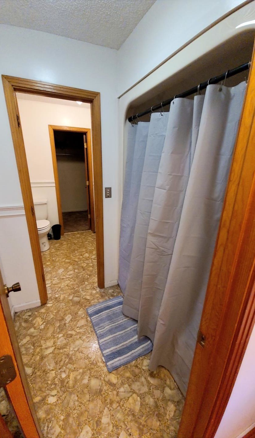 1360 Camden Bay Road Camden, TN 38320 - Photo 22 of 43 a view of walk in closet with wooden floor and chair