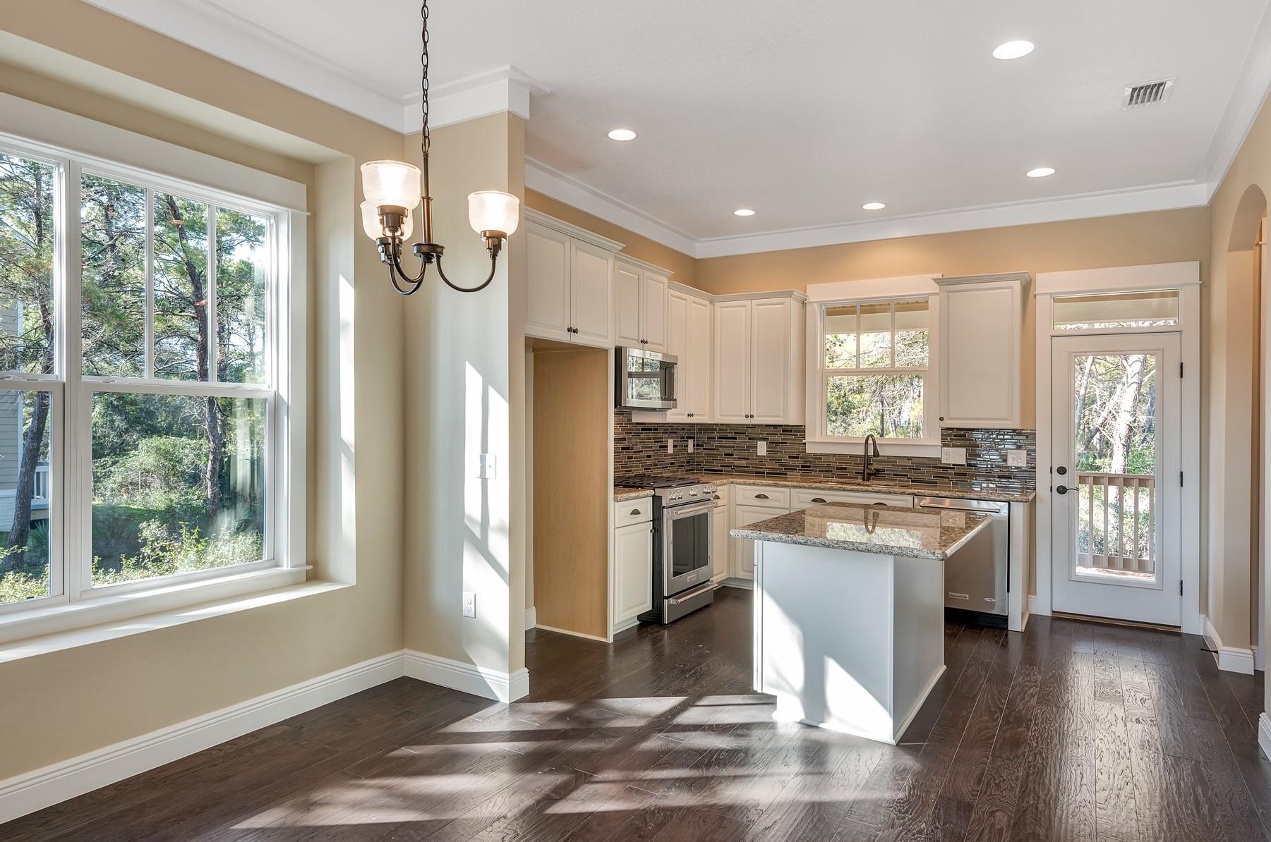 350 Grande Pointe Circle Inlet Beach, FL 32461 - Photo 7 of 21 a kitchen with stainless steel appliances granite countertop a refrigerator a sink dishwasher a stove and white cabinets with wooden floor