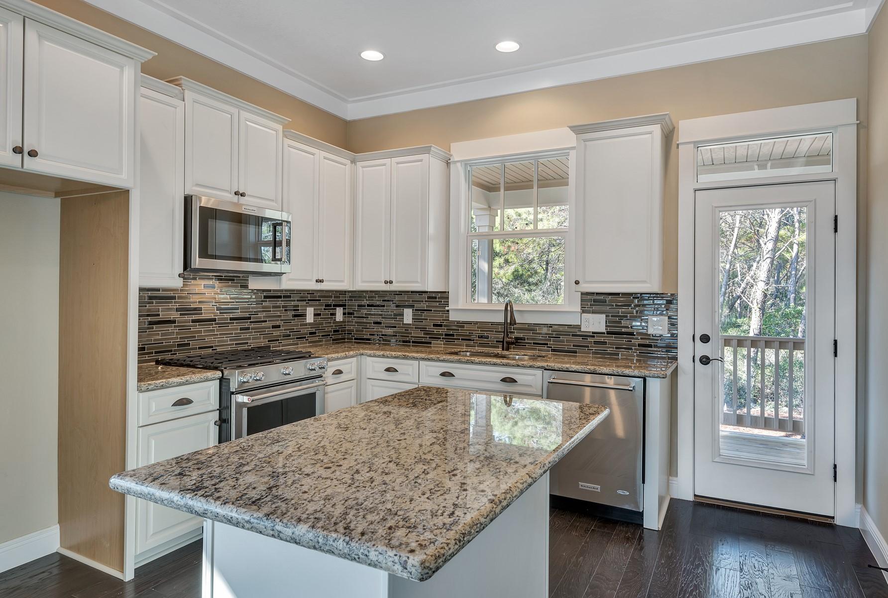 350 Grande Pointe Circle Inlet Beach, FL 32461 - Photo 8 of 21 a kitchen with stainless steel appliances granite countertop a stove a sink and a refrigerator
