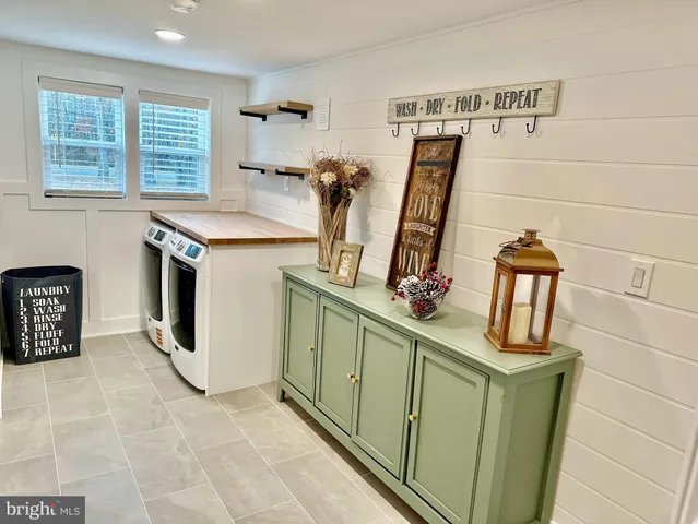 a view of a kitchen with fridge and window