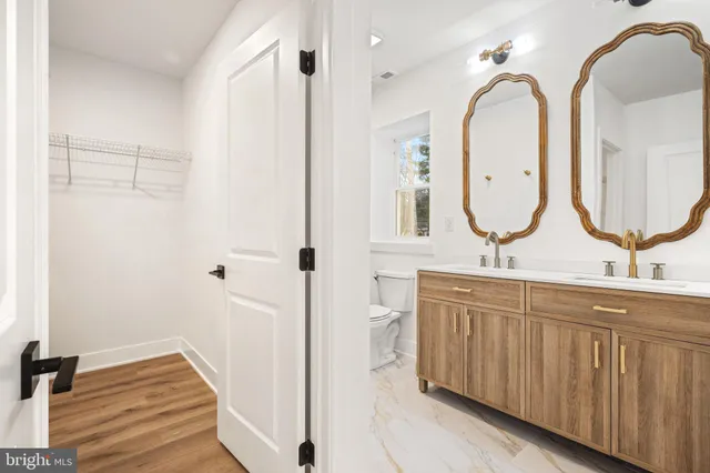 a bathroom with a double vanity sink and a mirror