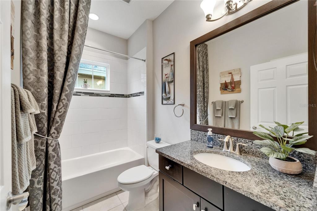 6127 Colmar Place Apollo Beach, FL 33572 - Photo 18 of 72 a bathroom with a granite countertop sink toilet and shower