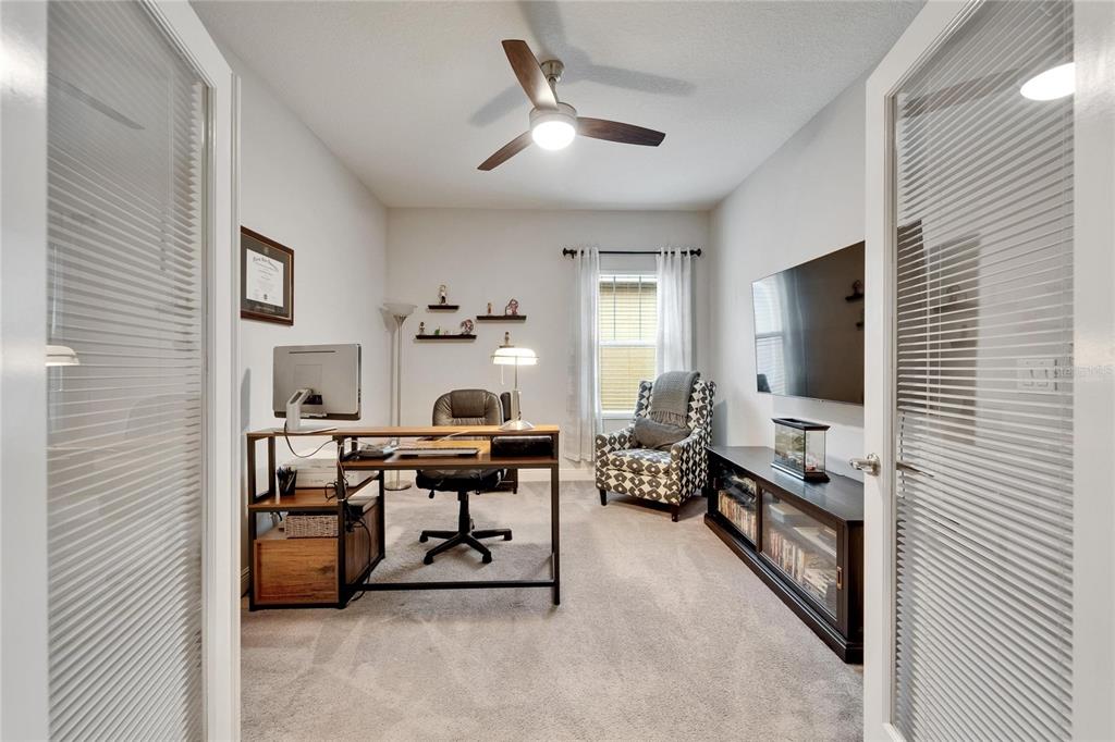 6127 Colmar Place Apollo Beach, FL 33572 - Photo 21 of 72 a view of a workspace with a window and lounge chair