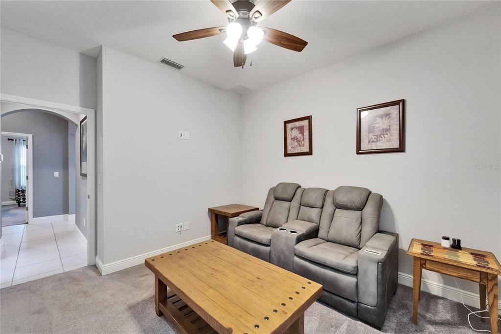 6127 Colmar Place Apollo Beach, FL 33572 - Photo 25 of 72 a living room with furniture and a ceiling fan