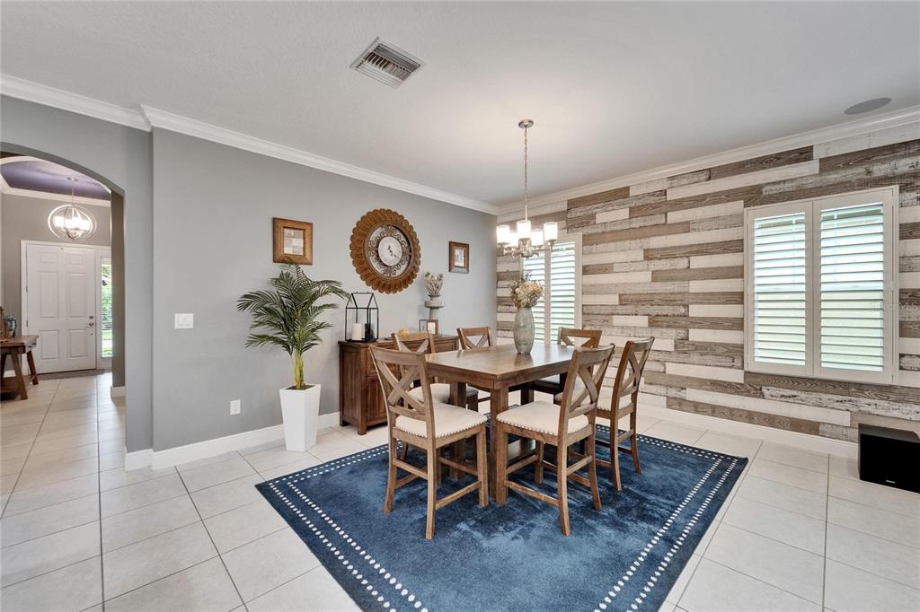 6127 Colmar Place Apollo Beach, FL 33572 - Photo 30 of 72 a view of a dining room with furniture window and wooden floor