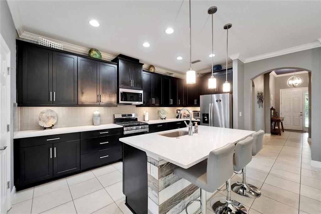 6127 Colmar Place Apollo Beach, FL 33572 - Photo 38 of 72 a large kitchen with a table and chairs