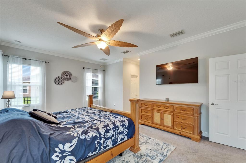 6127 Colmar Place Apollo Beach, FL 33572 - Photo 46 of 72 a bedroom with a bed and a flat screen tv