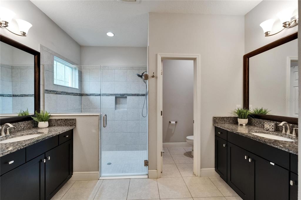 6127 Colmar Place Apollo Beach, FL 33572 - Photo 48 of 72 a bathroom with a granite countertop sink toilet and shower