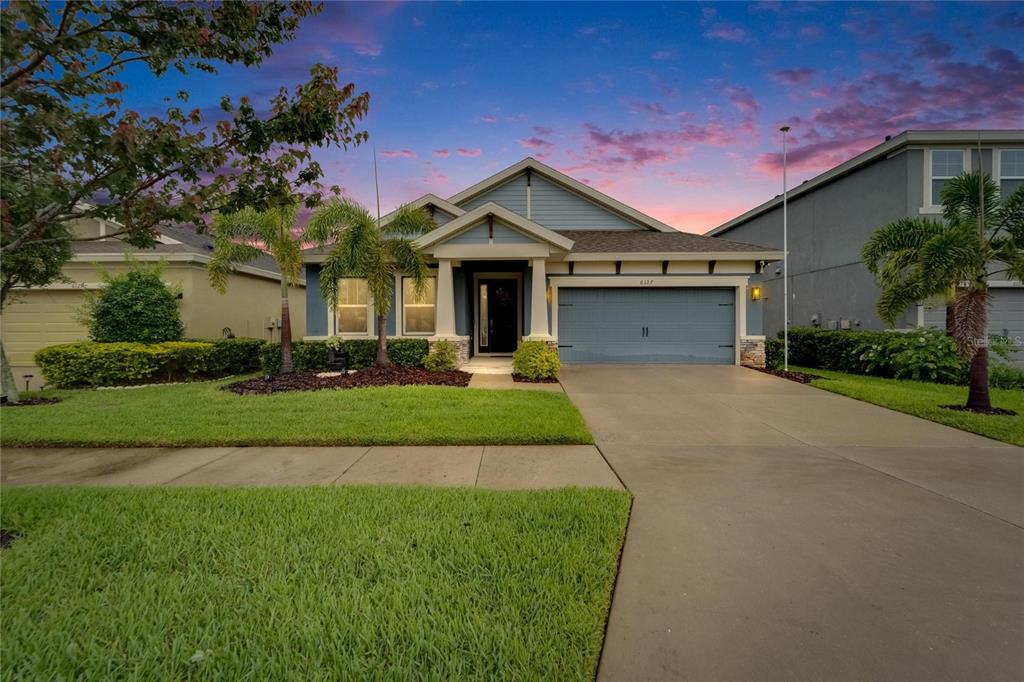 6127 Colmar Place Apollo Beach, FL 33572 - Photo 5 of 72 a front view of a house with a yard and garage