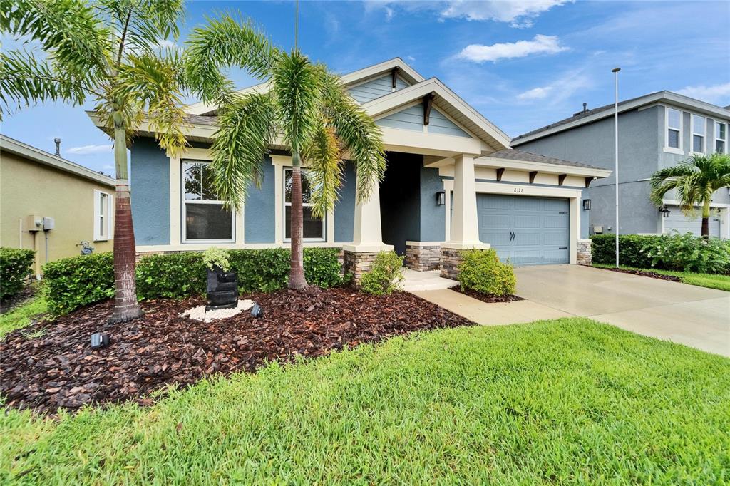 6127 Colmar Place Apollo Beach, FL 33572 - Photo 6 of 72 a front view of a house with a yard and potted plants