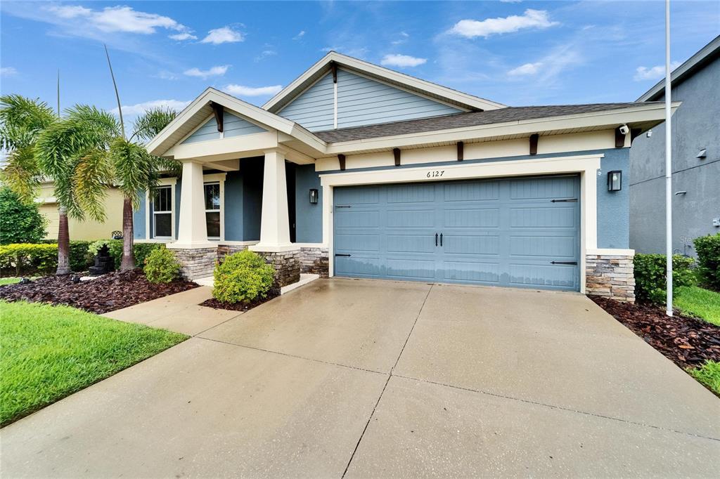 6127 Colmar Place Apollo Beach, FL 33572 - Photo 7 of 72 a front view of a house with a yard and garage