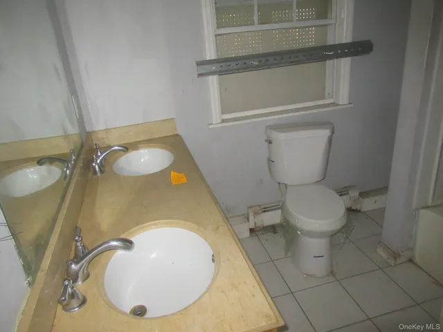 a bathroom with a toilet and a mirror