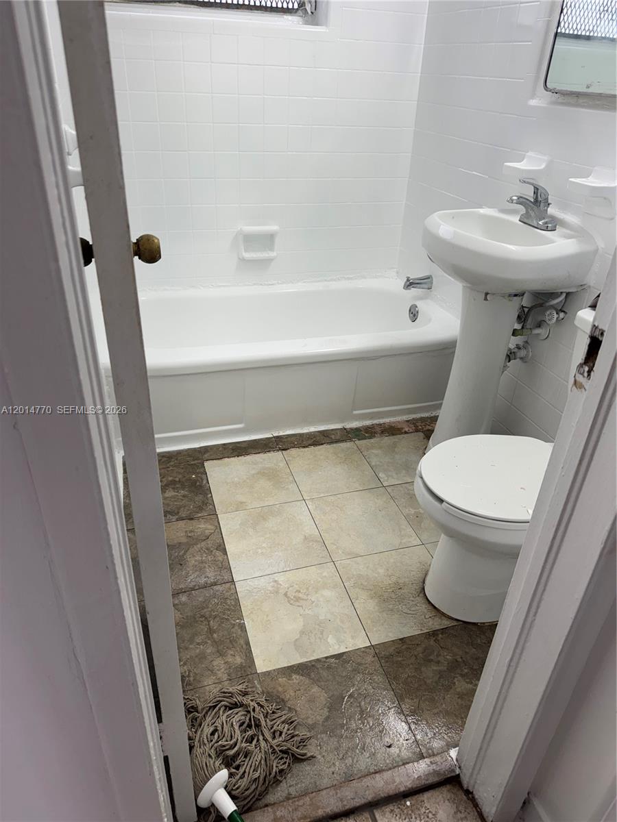 7300 Harding Avenue, Unit 9 Miami Beach, FL 33141 - Photo 4 of 4 a bathroom with a sink and a toilet