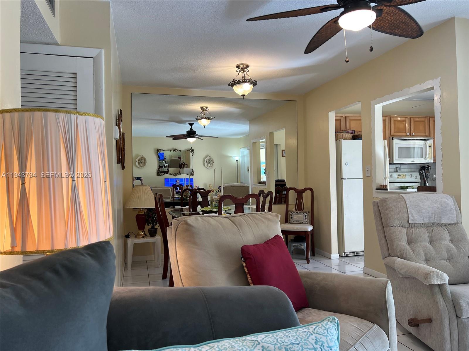 5300 Washington Street, Unit G123 Hollywood, FL 33021 - Photo 3 of 12 a living room with furniture and a chandelier