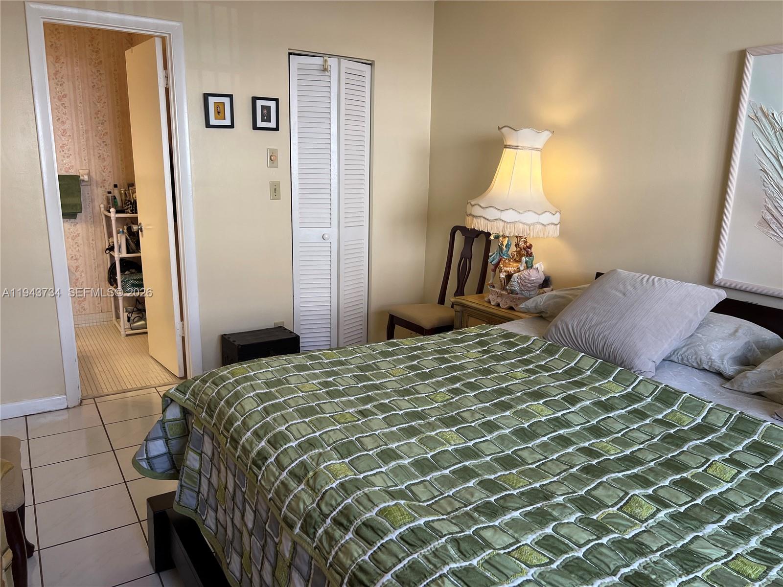 5300 Washington Street, Unit G123 Hollywood, FL 33021 - Photo 7 of 12 a bedroom with a bed and wooden floor