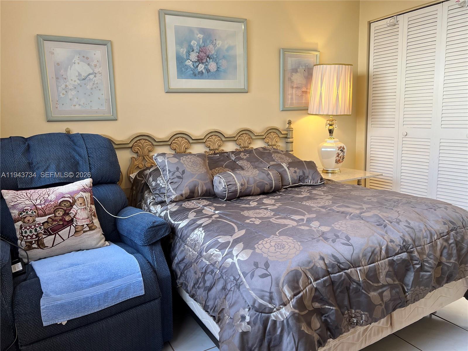 5300 Washington Street, Unit G123 Hollywood, FL 33021 - Photo 8 of 12 a bedroom with a bed and painting on the wall