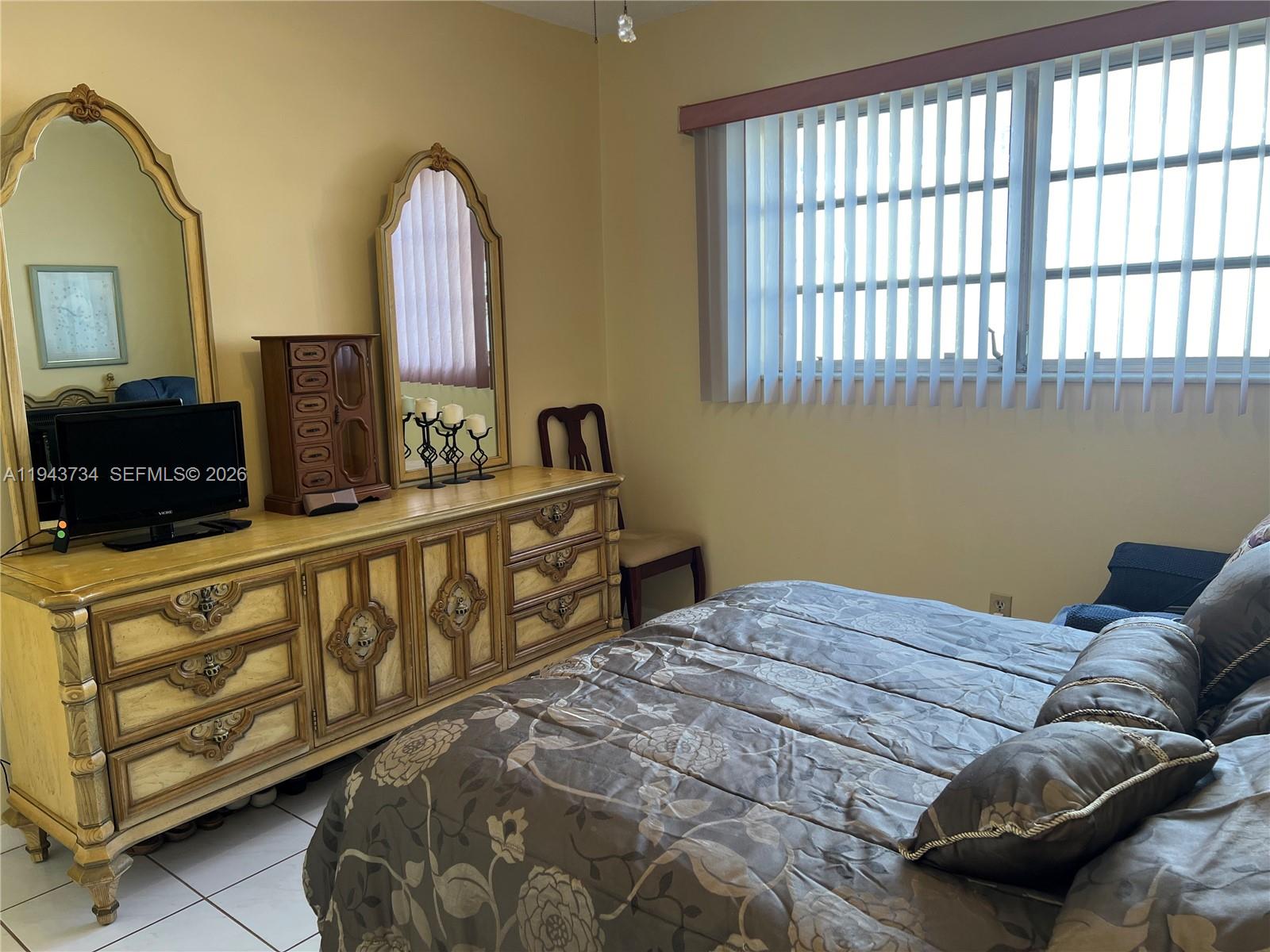 5300 Washington Street, Unit G123 Hollywood, FL 33021 - Photo 9 of 12 a bedroom with furniture and a window