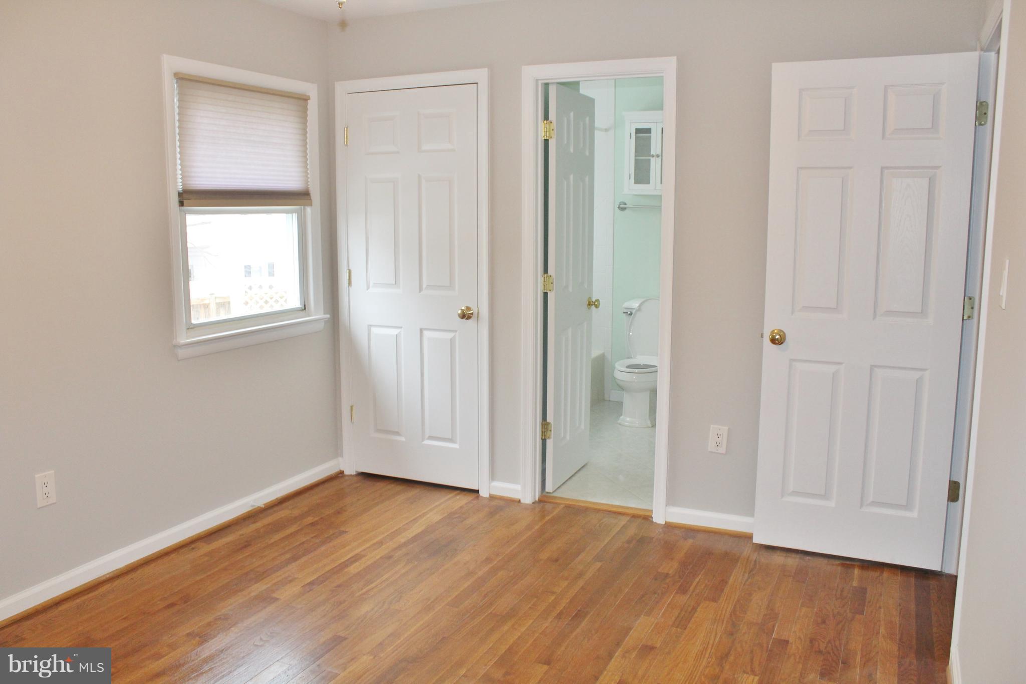 8004 Frye Road Alexandria, VA 22309 - Photo 11 of 21 an empty room with wooden floor and windows