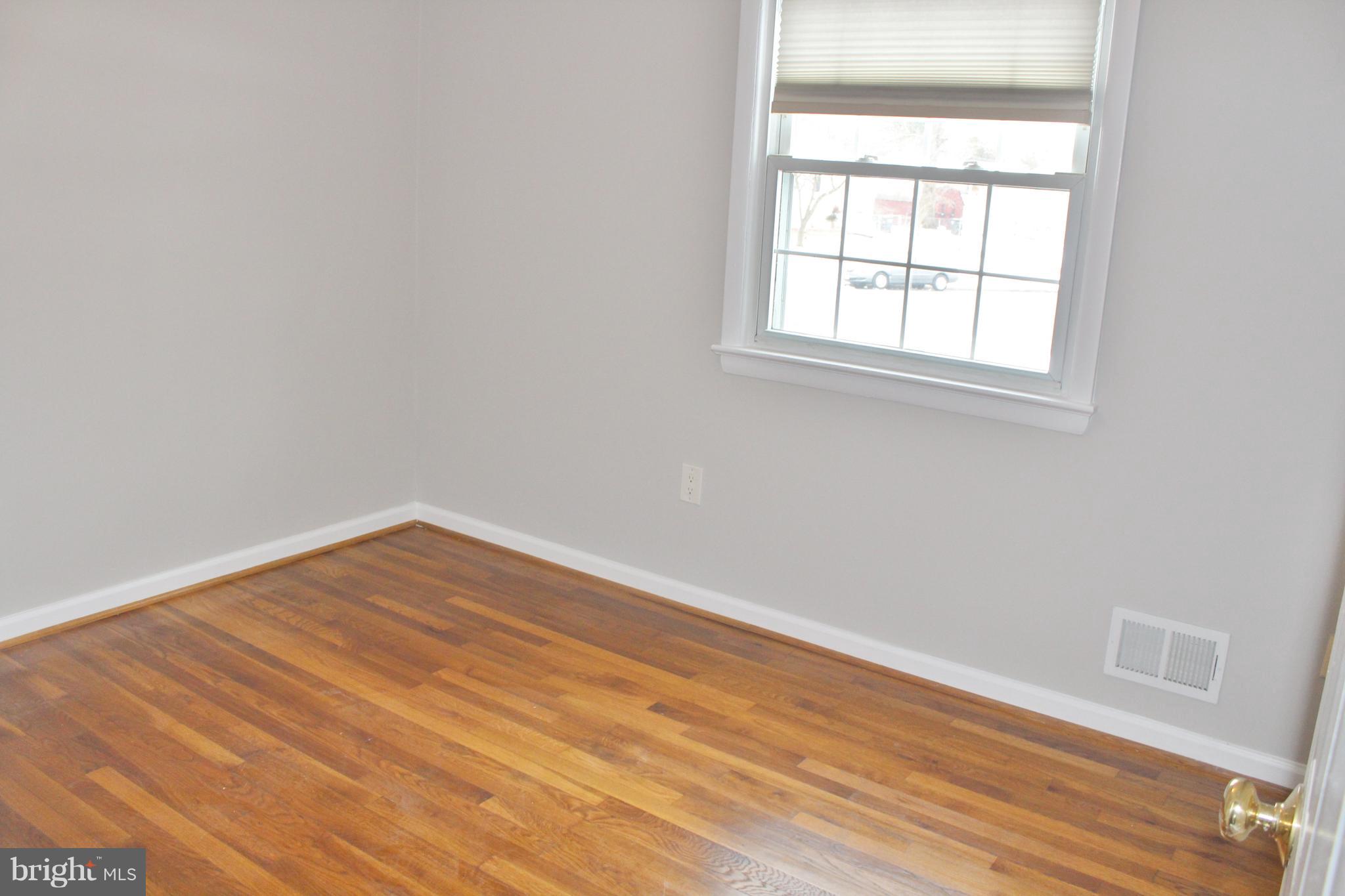 8004 Frye Road Alexandria, VA 22309 - Photo 12 of 21 an empty room with wooden floor and windows