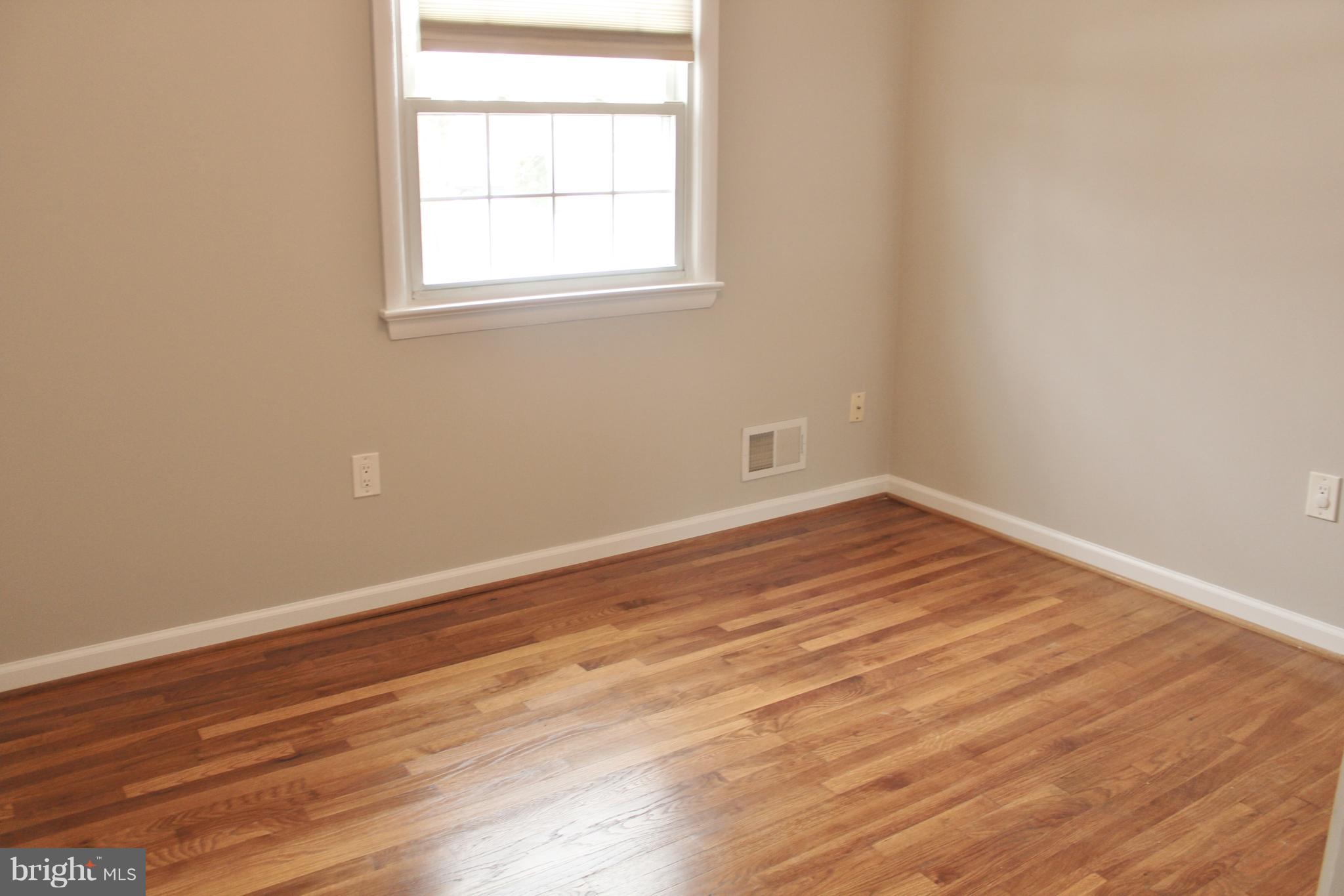 8004 Frye Road Alexandria, VA 22309 - Photo 13 of 21 an empty room with wooden floor and windows