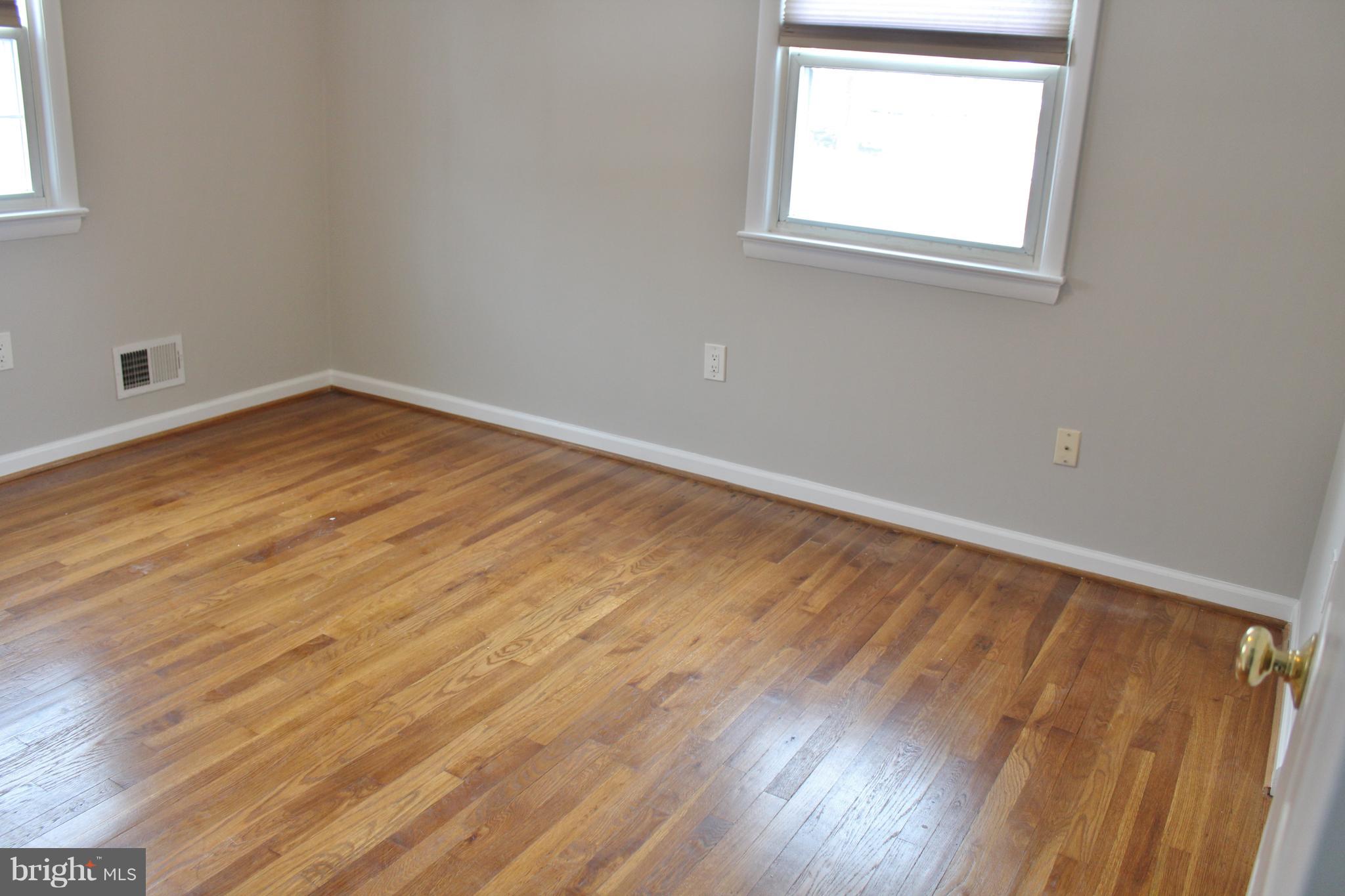 8004 Frye Road Alexandria, VA 22309 - Photo 14 of 21 an empty room with wooden floor and windows