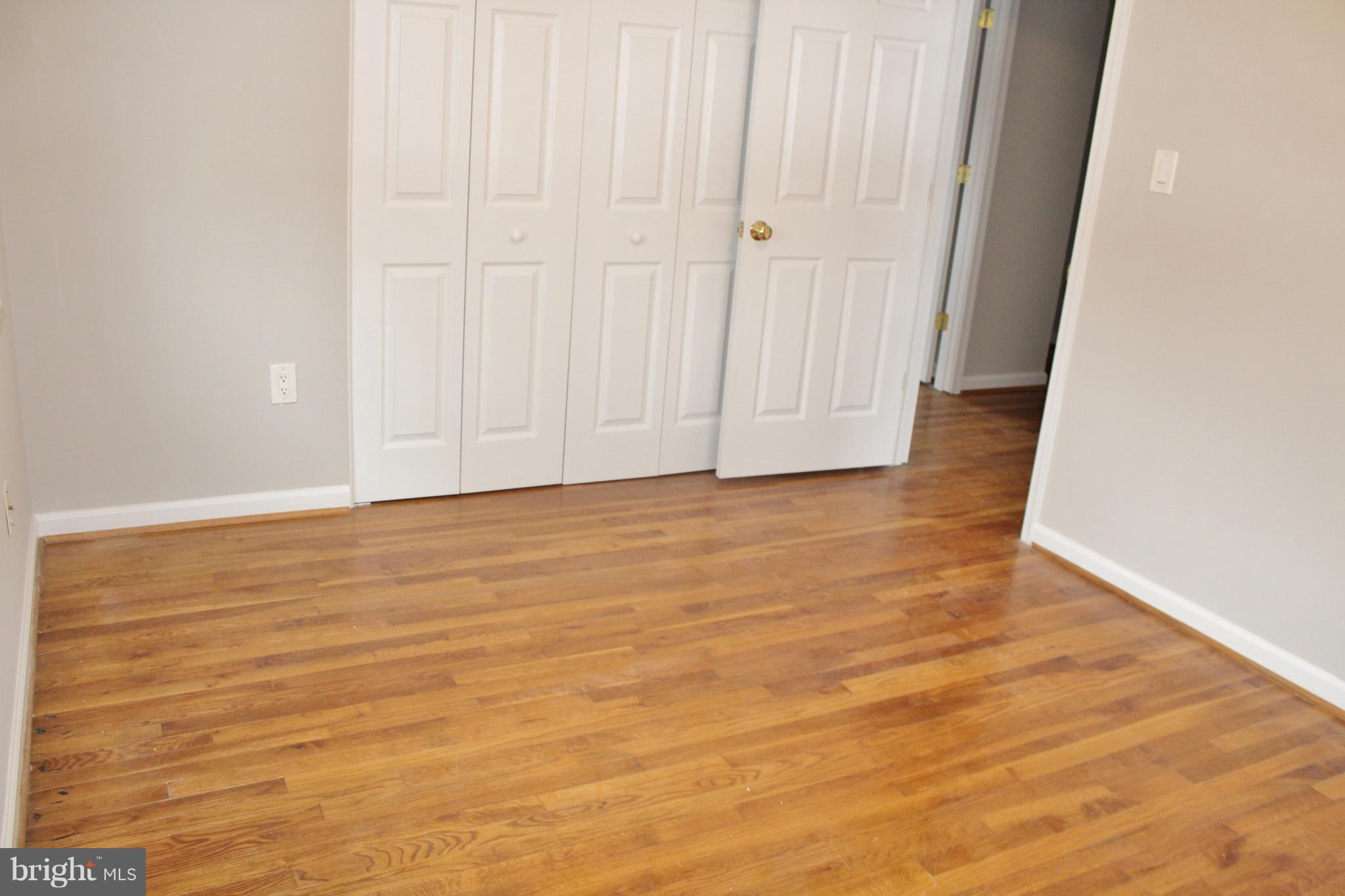 8004 Frye Road Alexandria, VA 22309 - Photo 15 of 21 a view of an empty room with wooden floor