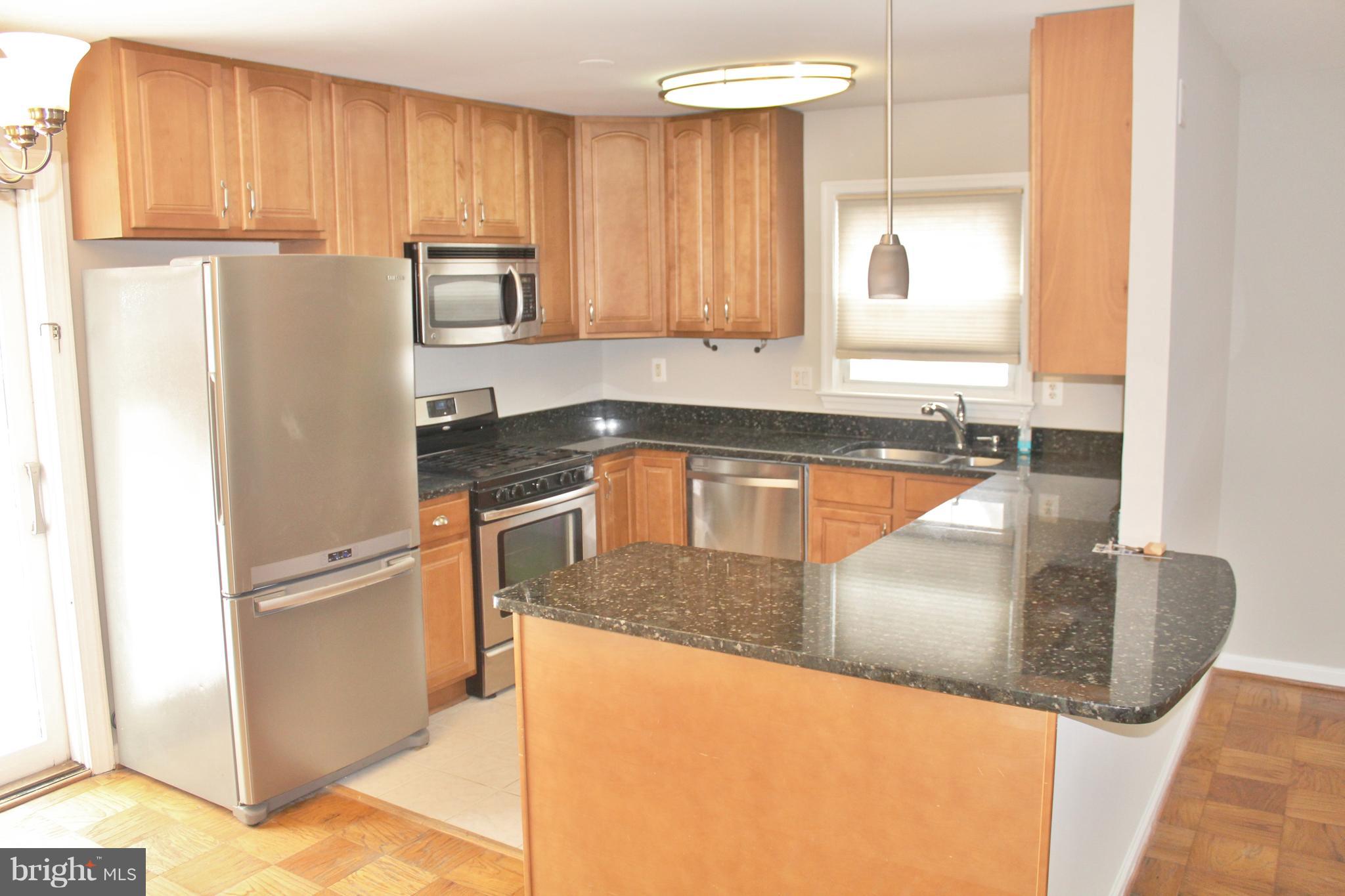 8004 Frye Road Alexandria, VA 22309 - Photo 7 of 21 a kitchen with granite countertop a refrigerator and a sink