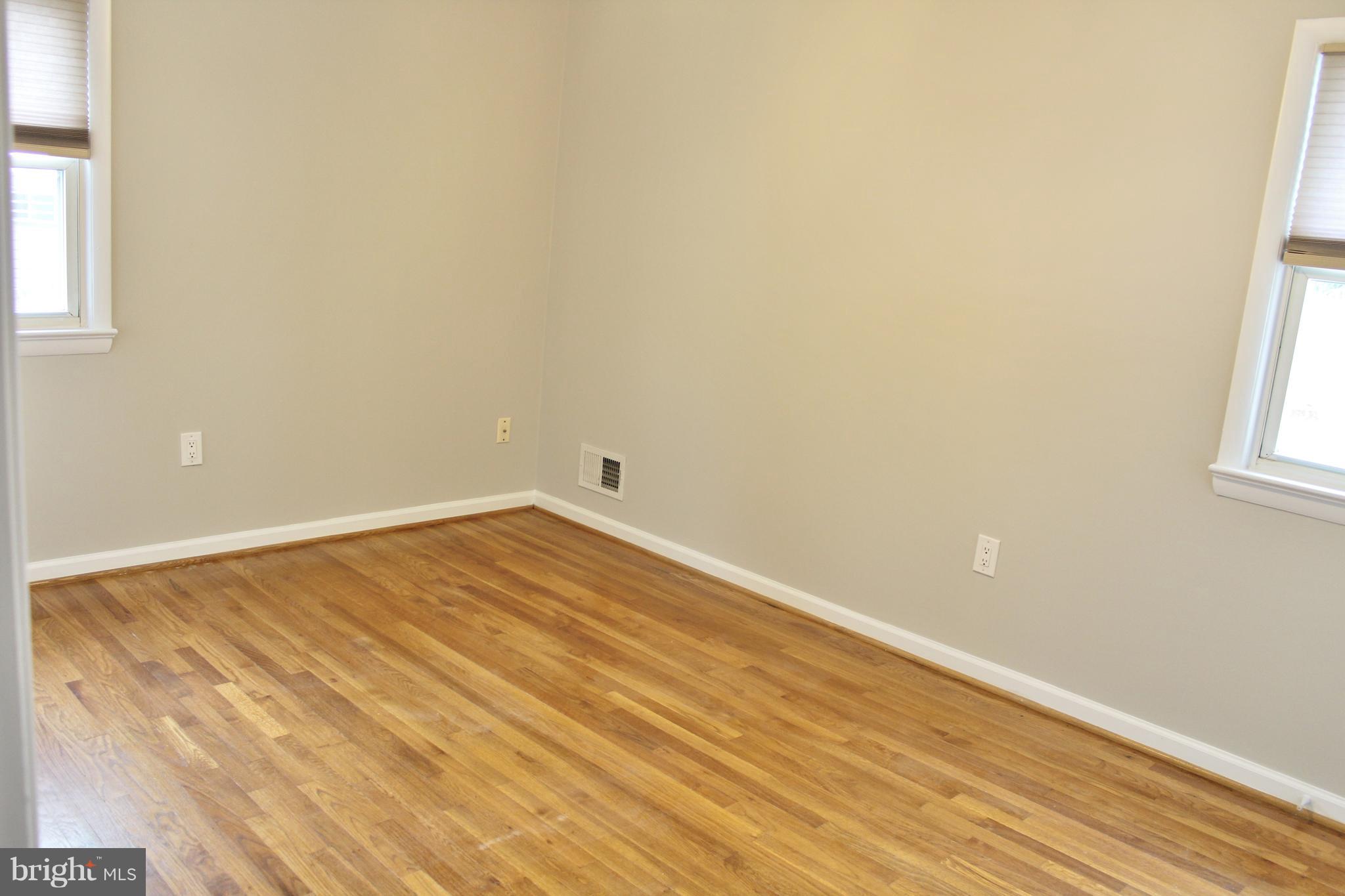 8004 Frye Road Alexandria, VA 22309 - Photo 9 of 21 an empty room with wooden floor and windows