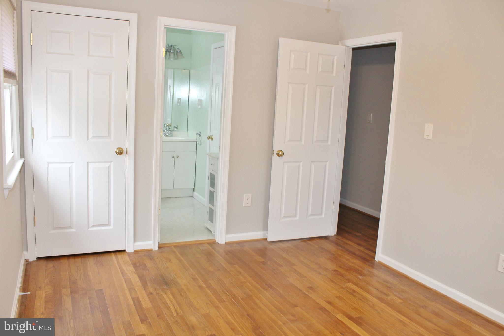 8004 Frye Road Alexandria, VA 22309 - Photo 10 of 21 an empty room with wooden floor and closet area