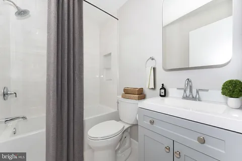 a bathroom with a sink a toilet and a bathtub