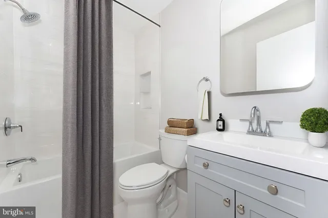 a bathroom with a sink a toilet and a bathtub