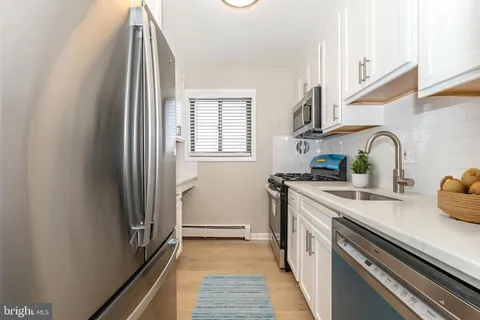 a kitchen with stainless steel appliances granite countertop a sink and a stove