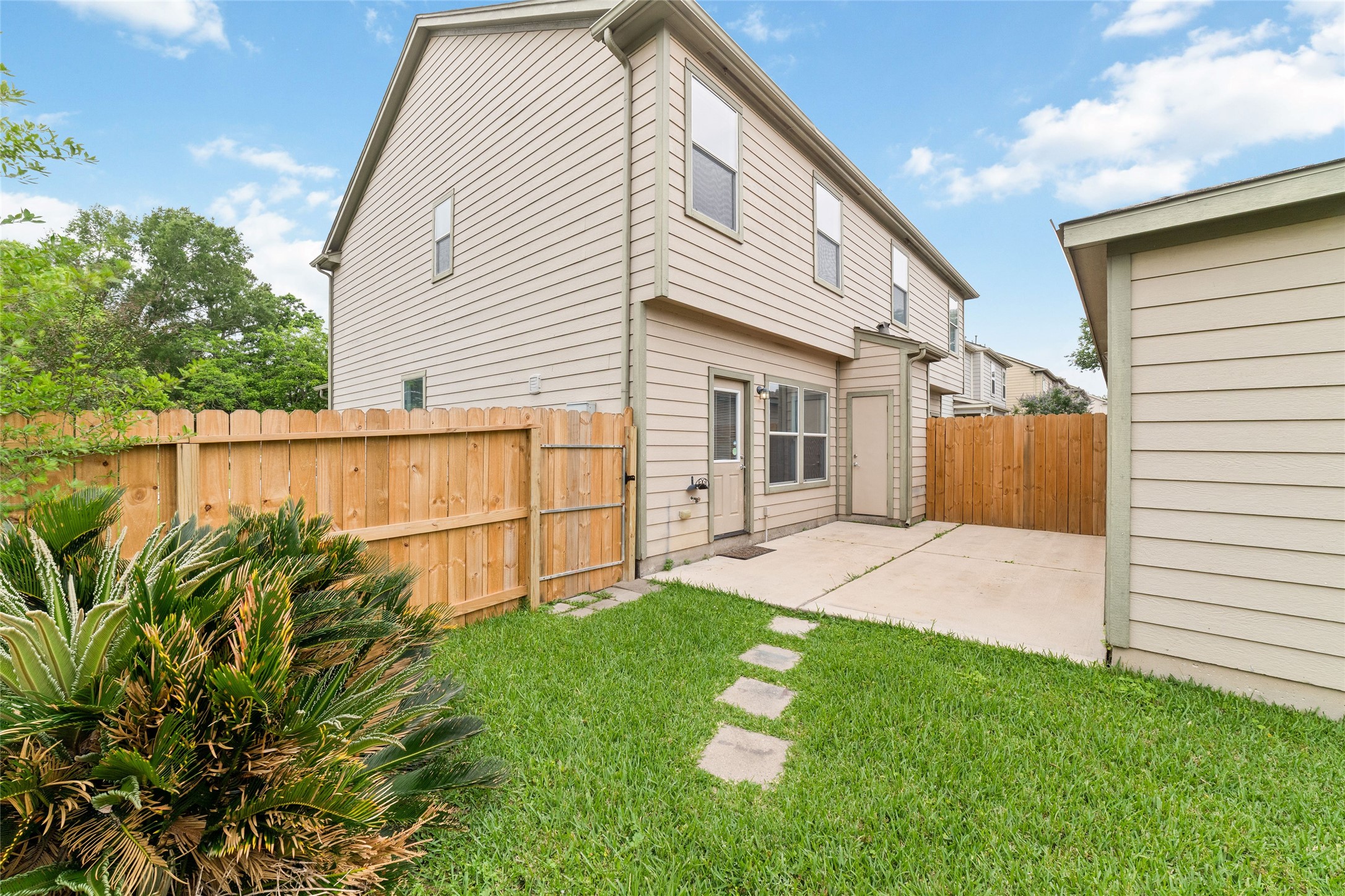 23602 Youpon Lake Lane Spring, TX 77373 - Photo 19 of 21 Fully fenced backyard with green space, stepping stones, and a private patio area for outdoor enjoyment.