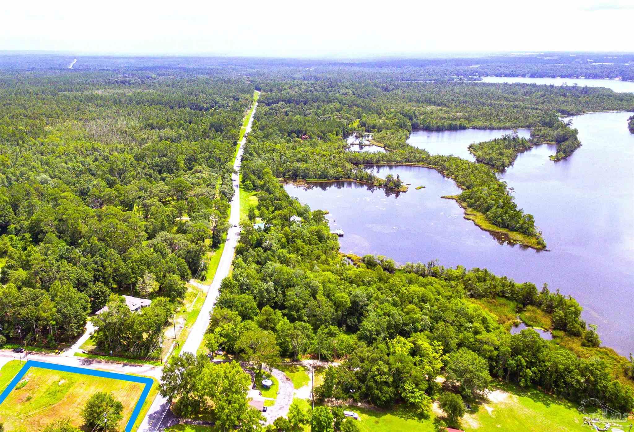 5563 Munson Lane Milton, FL 32570 - Photo 3 of 3 a view of a lake with houses in the back