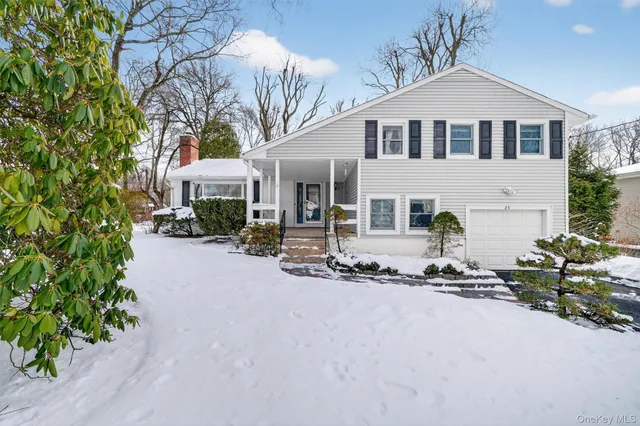 a living room with furniture a fireplace and wooden floor